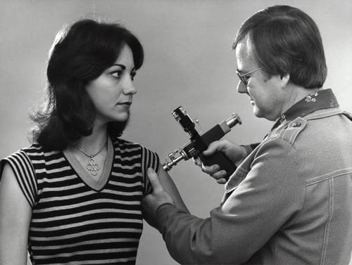 woman receiving swine flu vaccination in 1976  