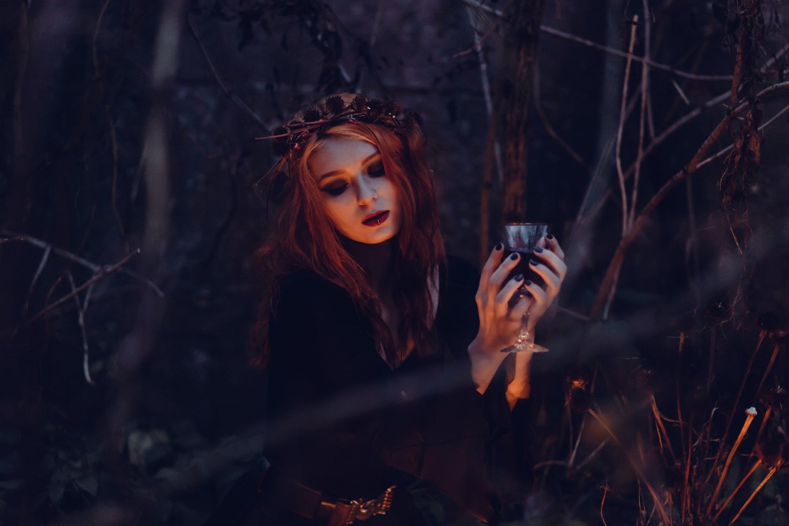 Woman dressed as witch holding a cup