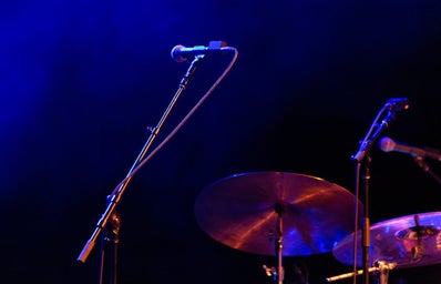 dark purple hues with microphone and drumset on the lower right