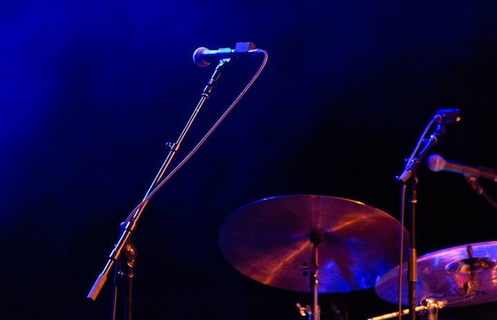 dark purple hues with microphone and drumset on the lower right