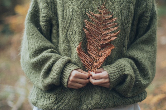 woman in sweater holding leaf by Elina Sazonova?width=698&height=466&fit=crop&auto=webp