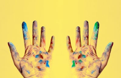paint-splattered gloves against yellow background