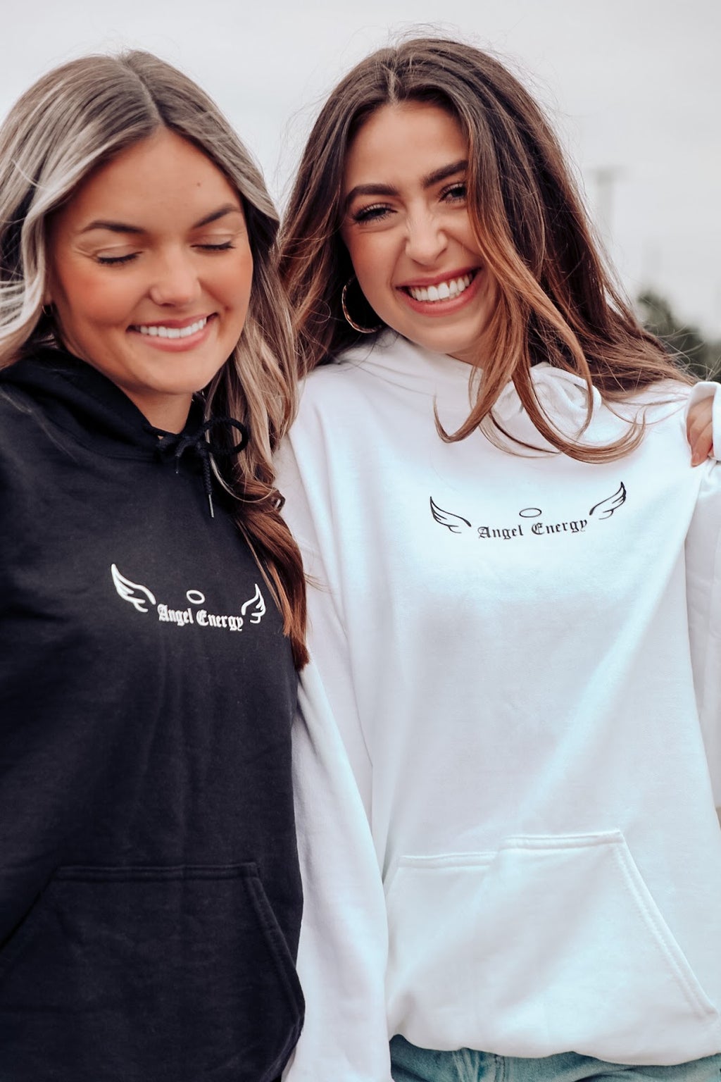 two girls in white and black sweatshirt
