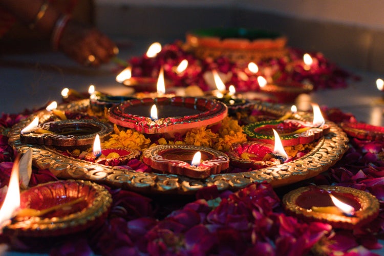 Beautiful combination of diyas and candles layed out for Diwali