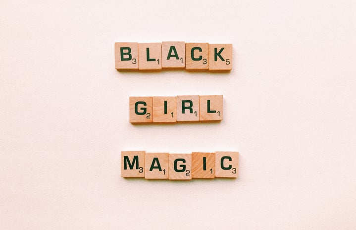 black girl magic letters against pink background