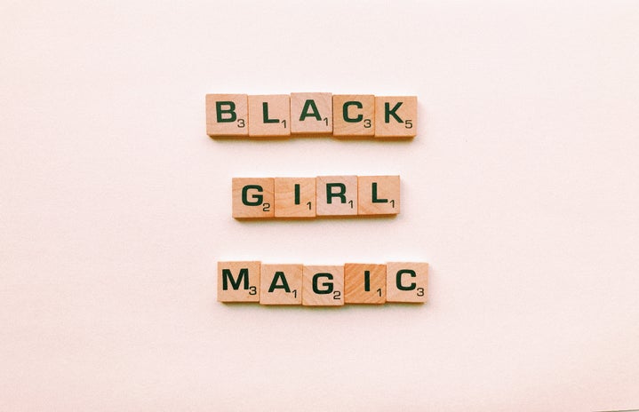 black girl magic letters against pink background