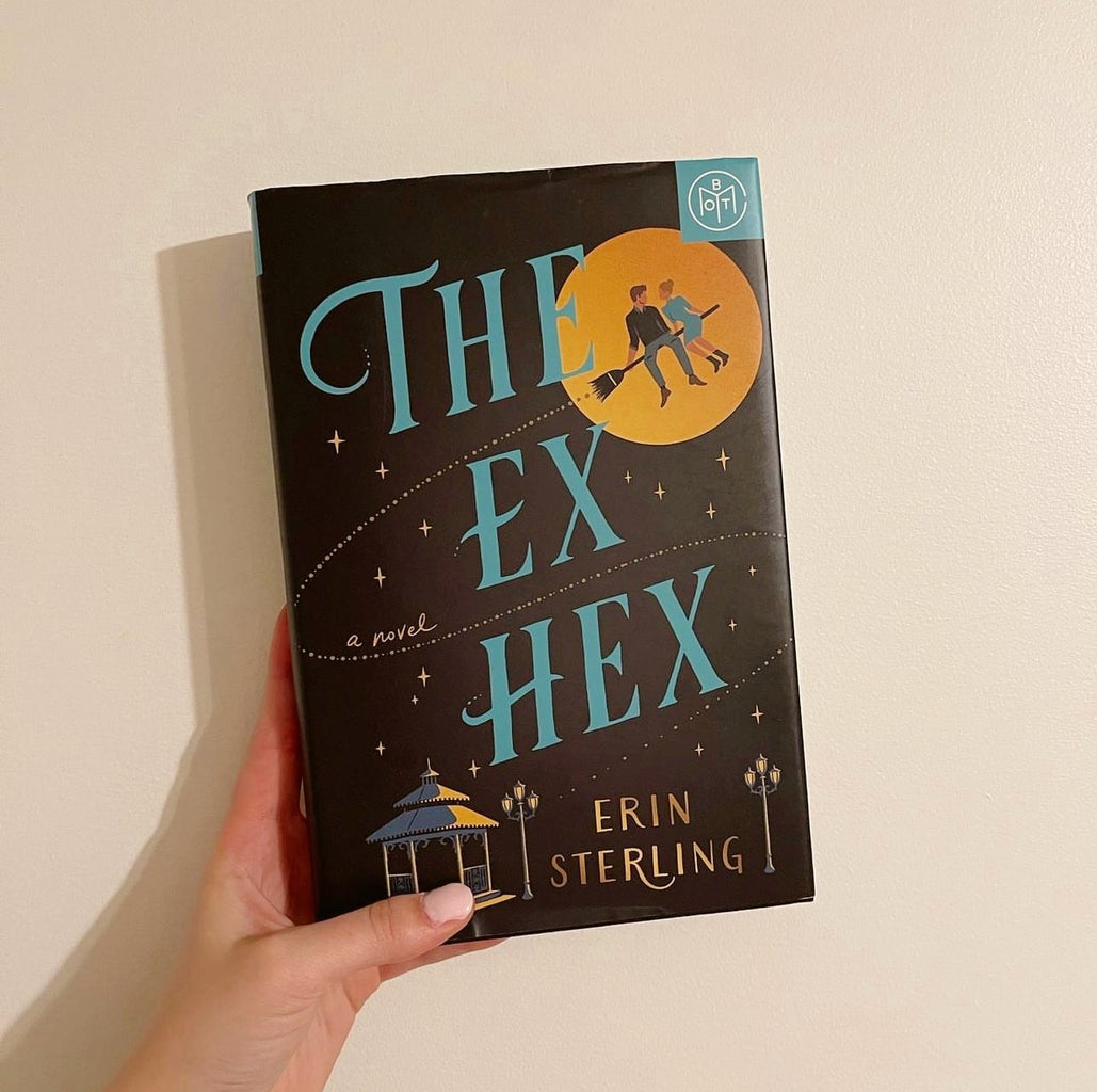 Photo of hand holding book. The ex hex