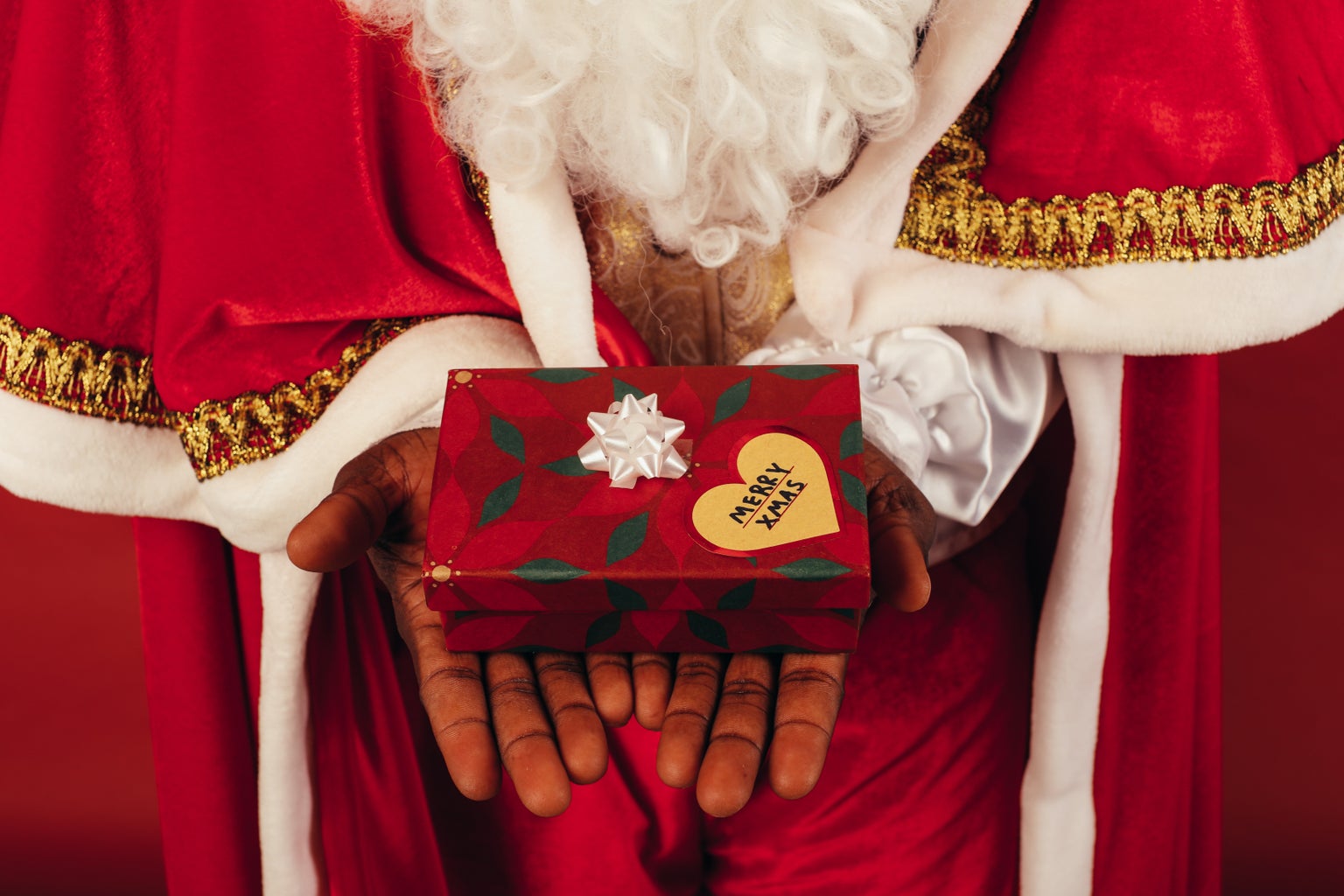 Santa Claus holding a present that reads \