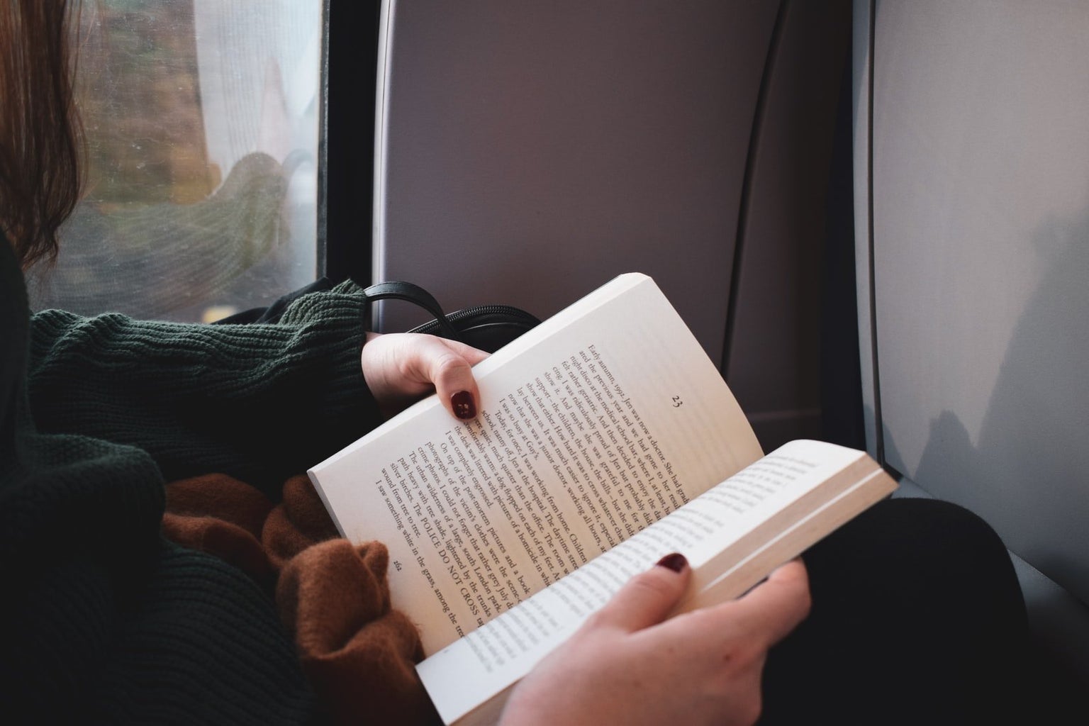 girl reading on train