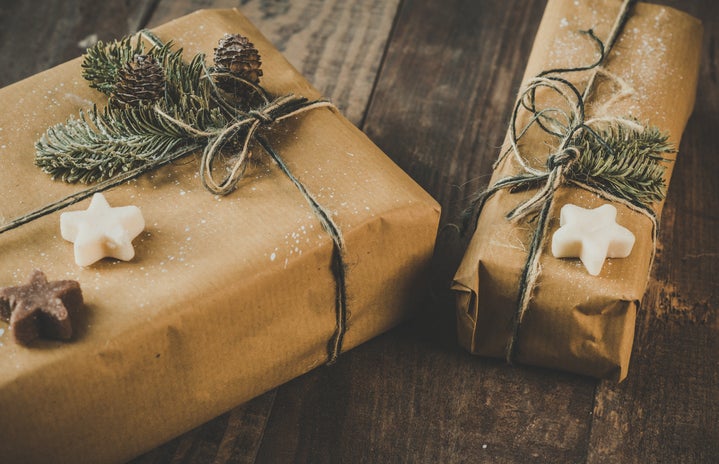 two gifts are wrapped in brown paper and covered with green and star-shaped soaps.