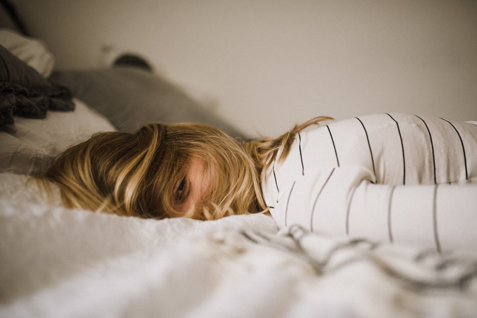 girl laying in bed feeling stressed out