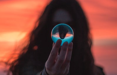 Girl holding sphere with her reflection