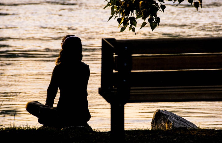 Woman sitting by the river at sunset by Unsplash?width=719&height=464&fit=crop&auto=webp