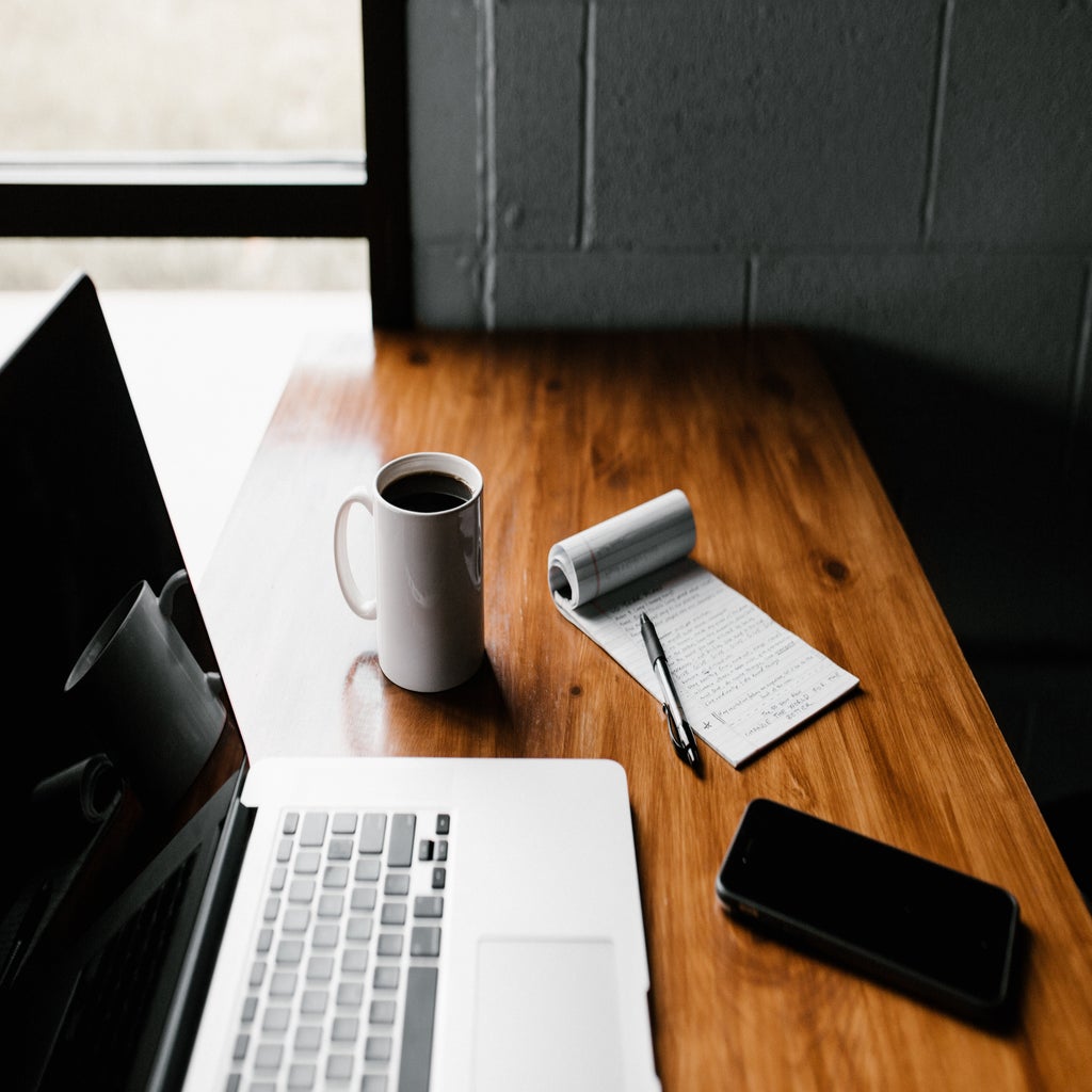 laptop and notepad on desk