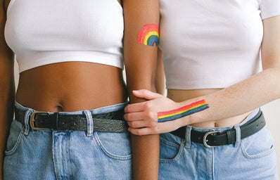 Women with gay pride paint