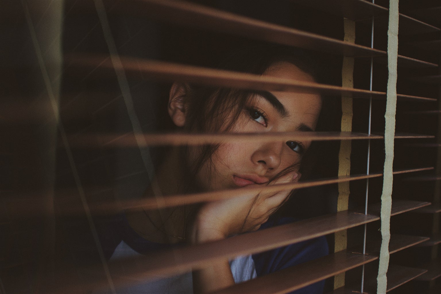 bored woman looking out the window