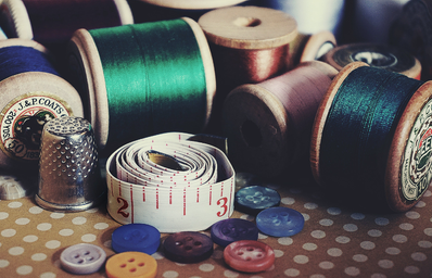 thread, tape measure, and buttons for sewing