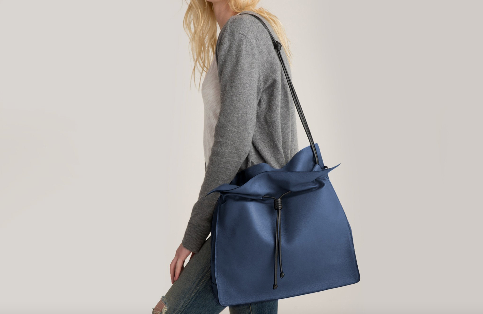 Von Holzhausen the large shopper, woman holding large blue bag over one shoulder