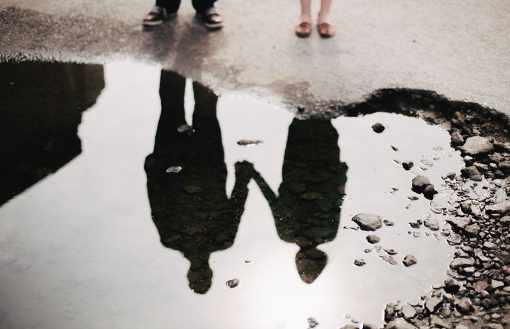 A couple looking at their reflection in water