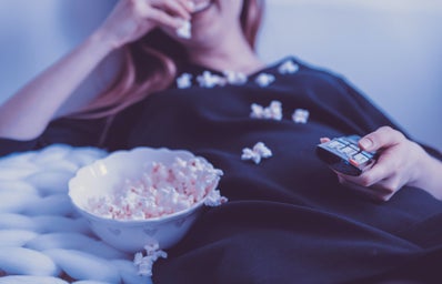 woman wearing black shirt eating popcorn