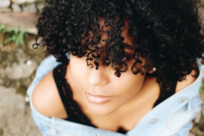 black curly hair from abovejpg by Unsplash?width=698&height=466&fit=crop&auto=webp