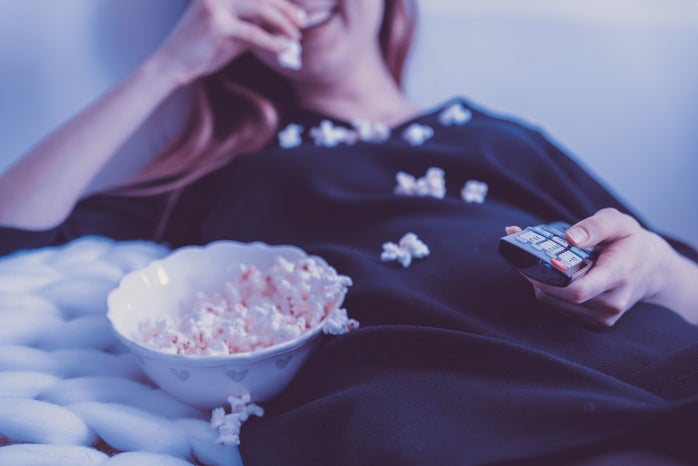 girl in bed with popcorn