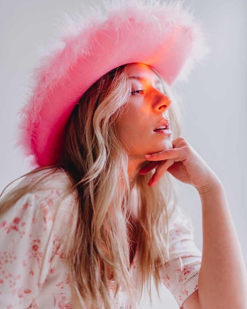 Blonde girl in a pink cowgirl hat