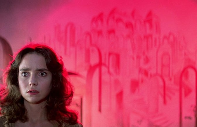 A picture of Suzy Banion, the protagonist of the 1977 horror classic Suspiria, against a brightly colored wall.