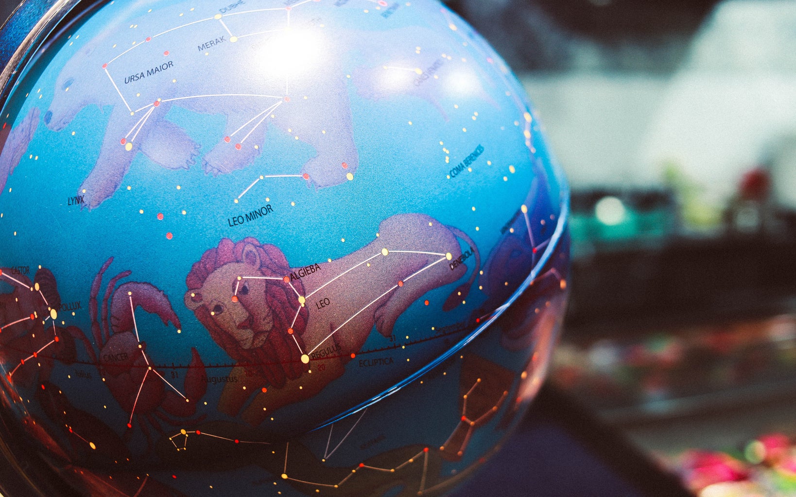 A blue globe with zodiac sign wallpaper