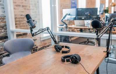 two black headphones on a desk