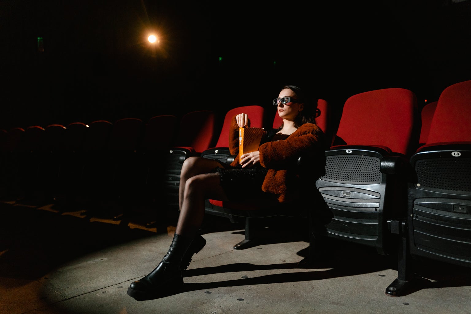 woman with 3d glasses sitting in movie theatre