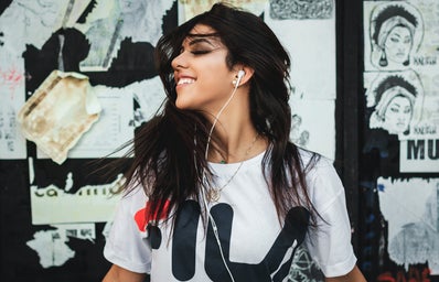 woman with earbuds in smiling