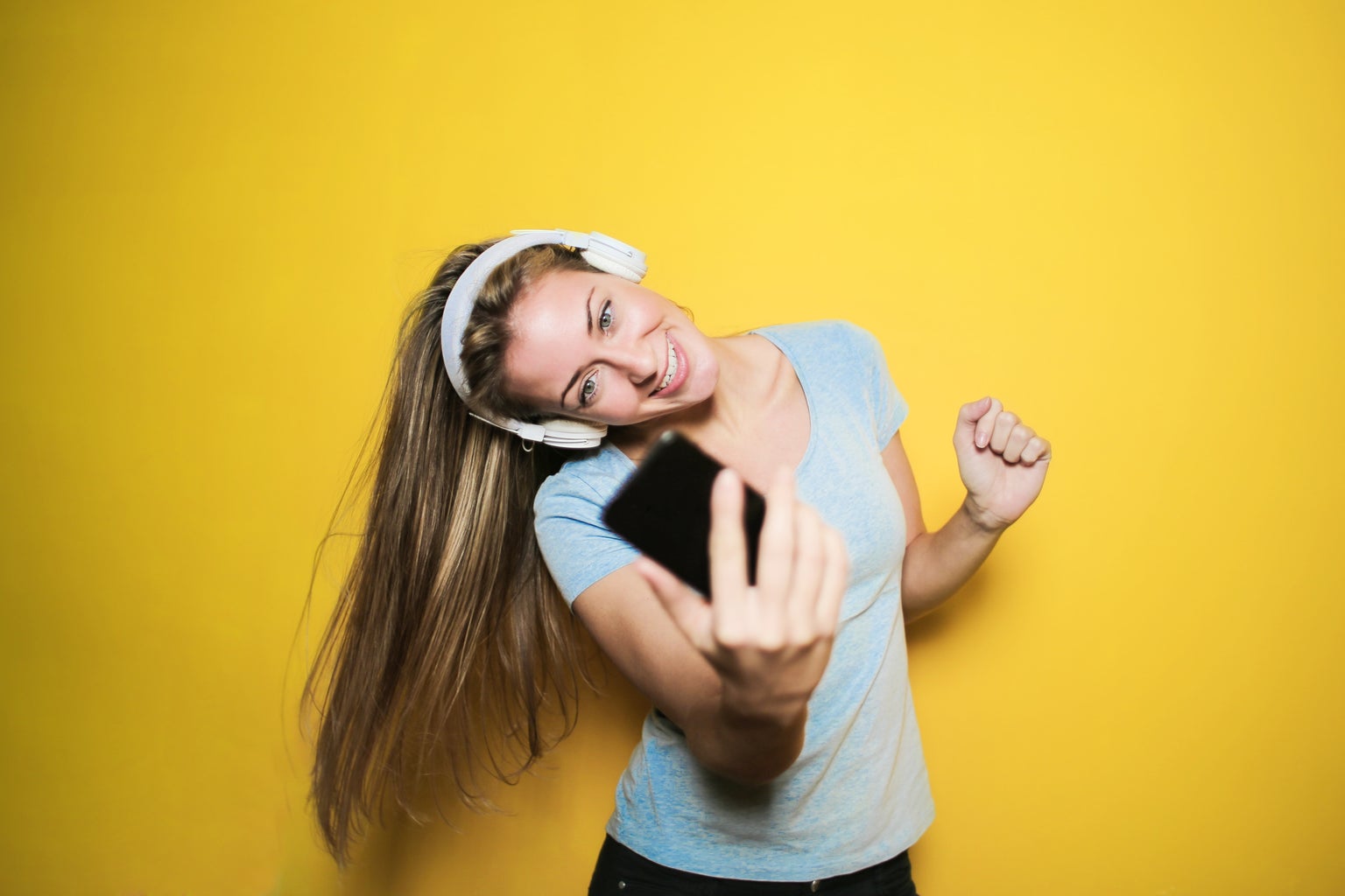 happy woman taking selfie on phone