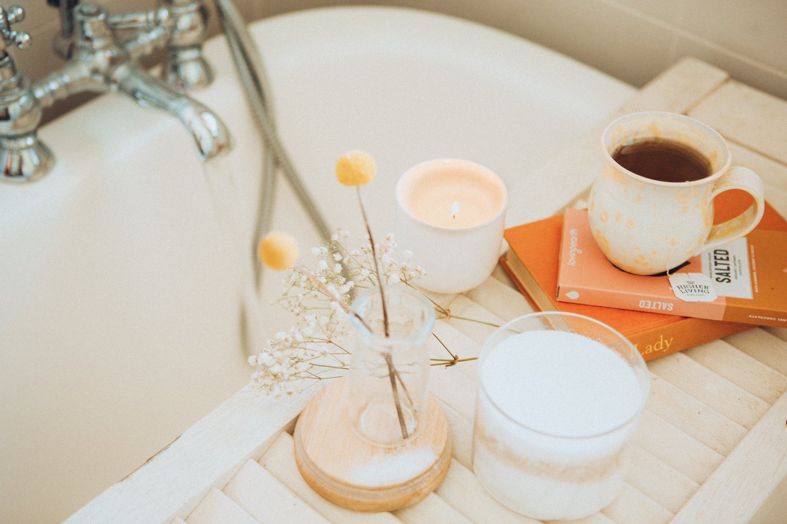 Tea cup and candle by a bath tub