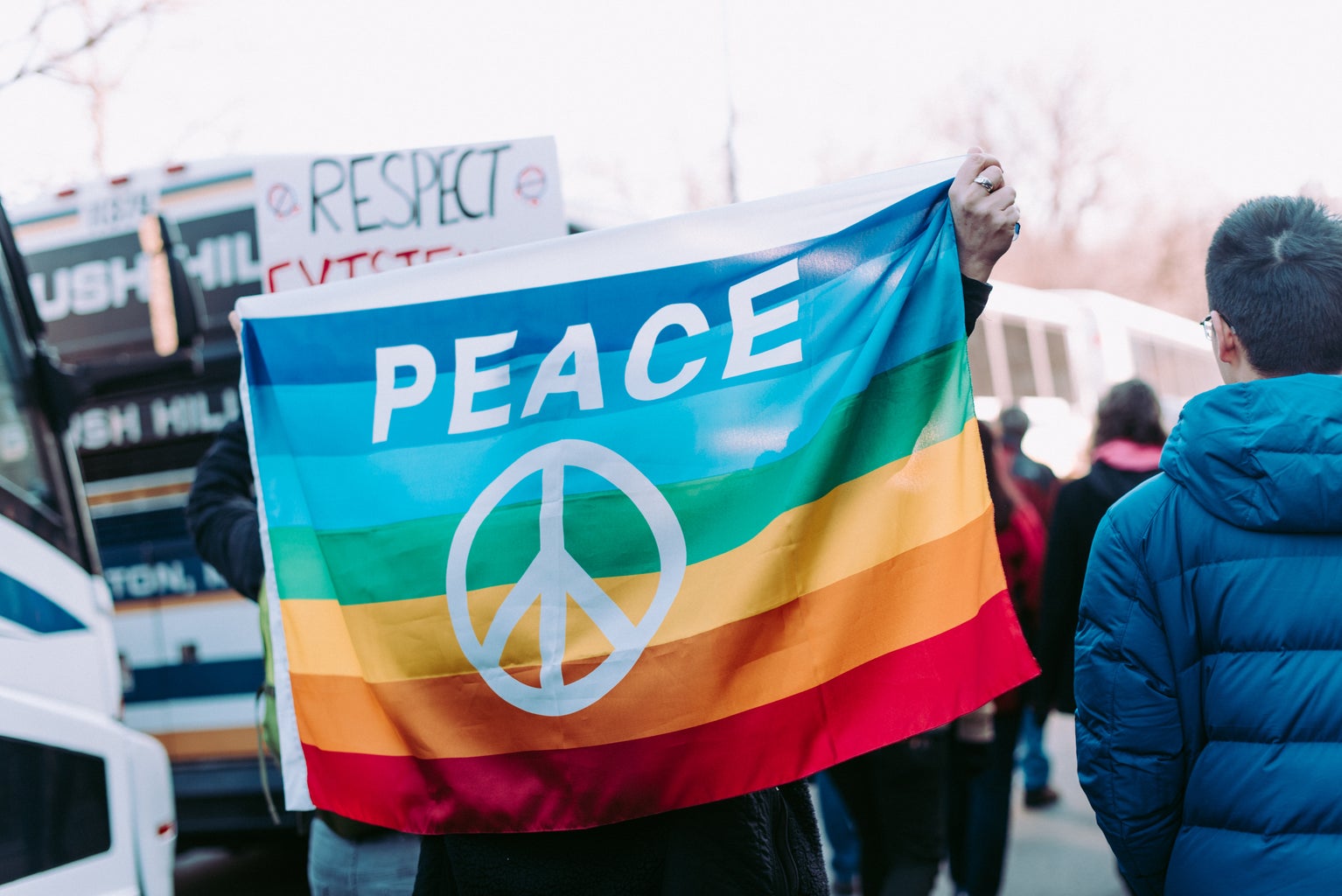 LGBTQ Protest banner- holding up a plea for peace for members of the LGBTQ community