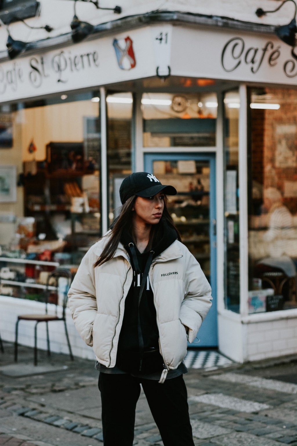 woman wearing puffer jacket and hat fashion in Bristol