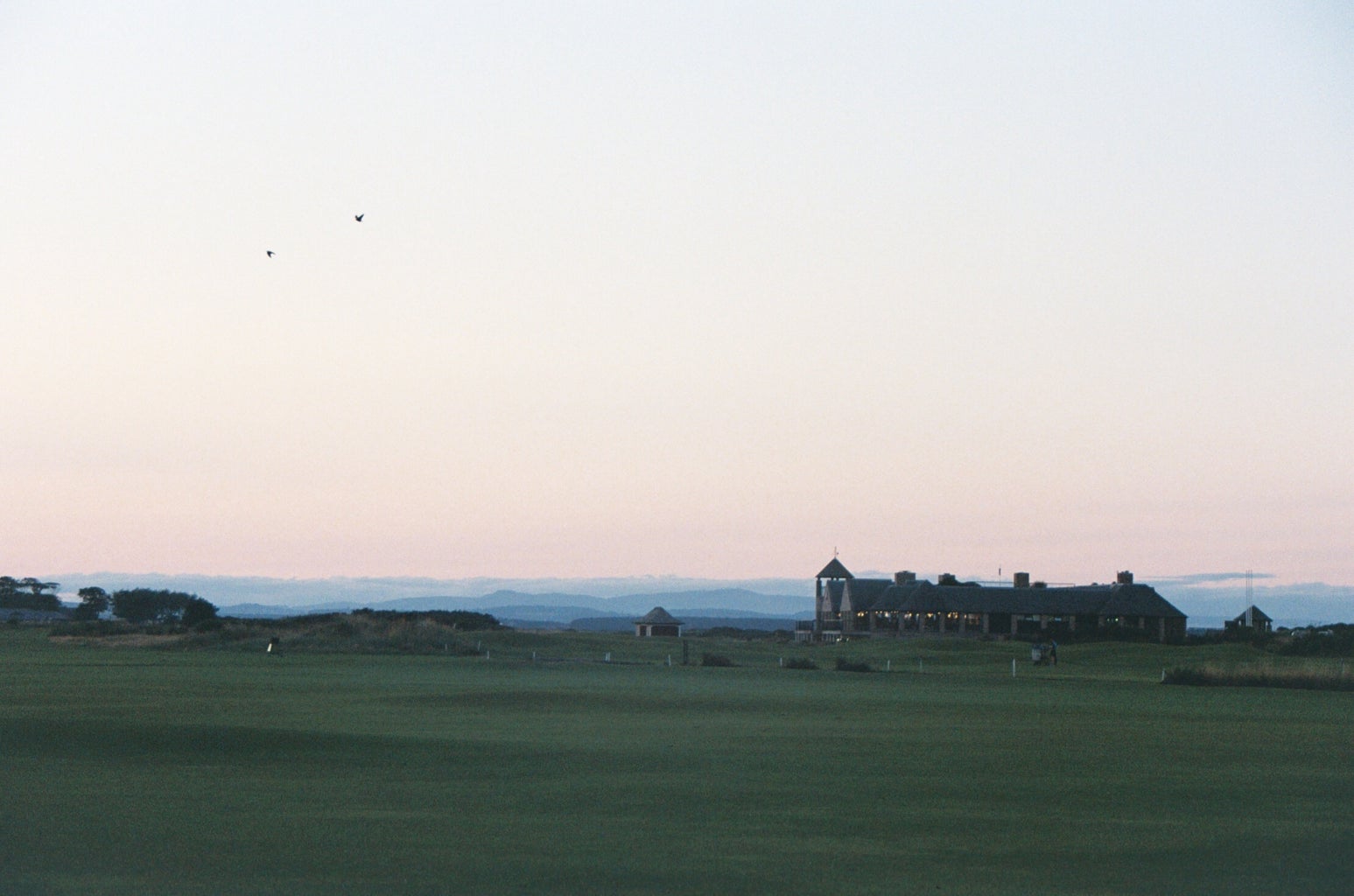 scenic view of a golf course at dusk
