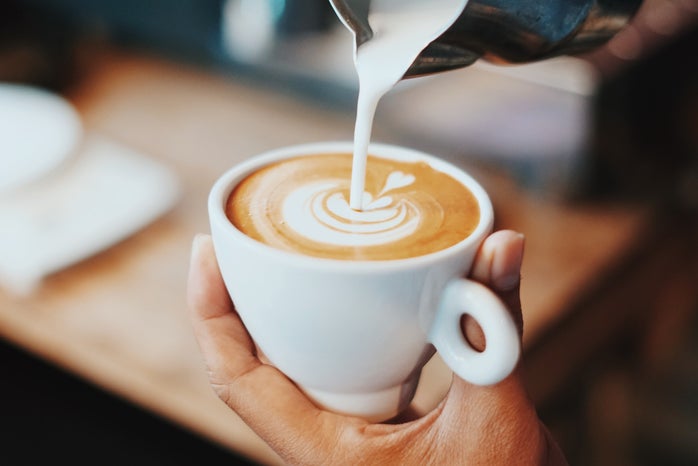 Person making latte art.