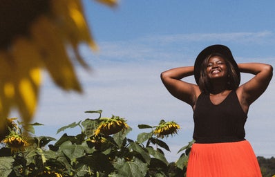 Woman smiling in sunflower field