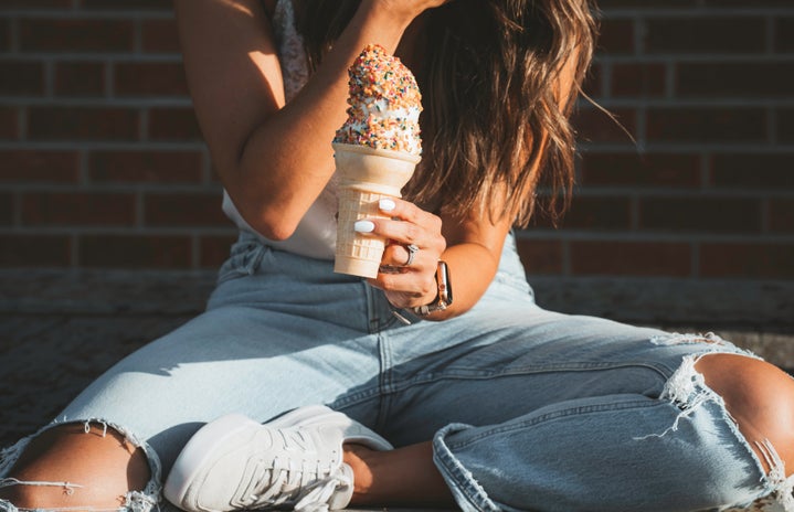 woman in jeans holding ice cream cone by Jason Yoder via Unsplash?width=719&height=464&fit=crop&auto=webp