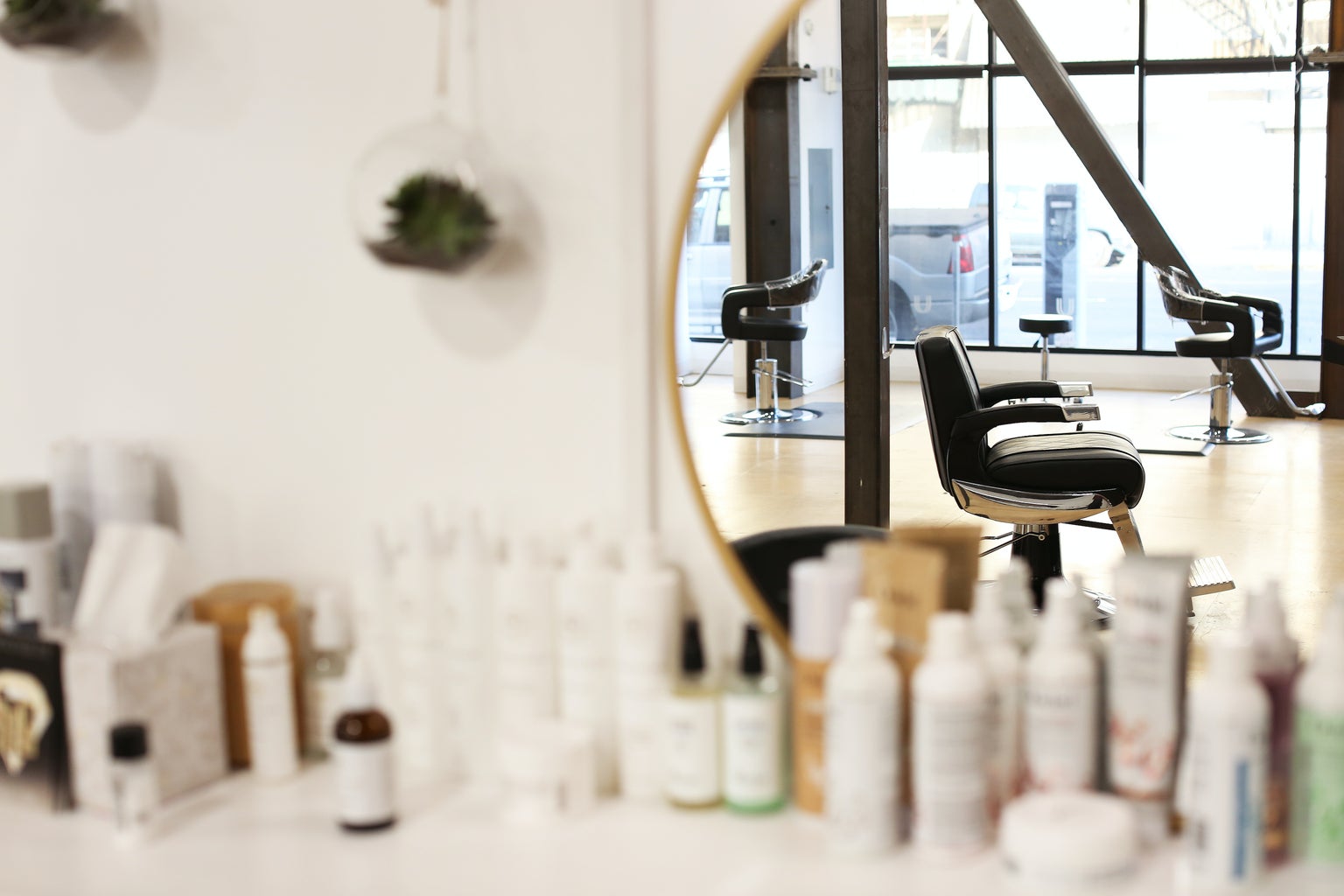 Hair salon in a mirror with hair products on the counter
