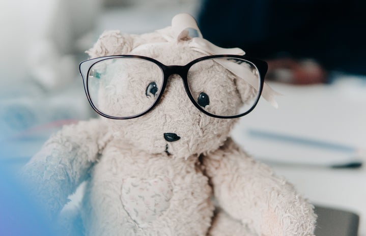 white bear plush toy wearing eyeglasses
