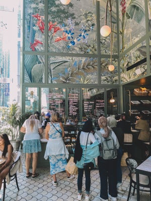 Inside of french coffee shop with green colorful mural