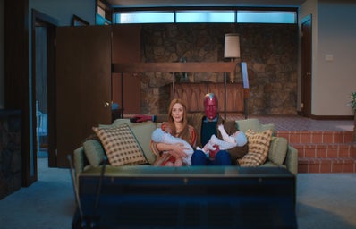 Wanda and Vision holding babies in front of a TV in Wandavision
