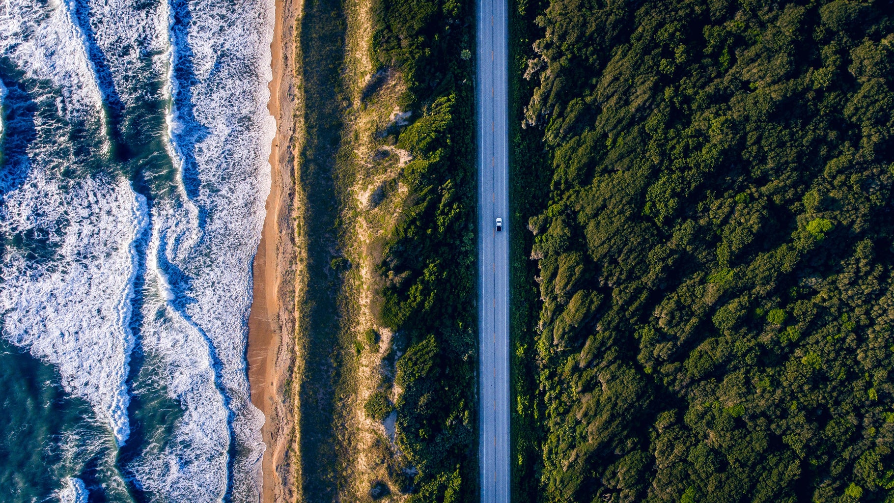 lone car driving on a pacific highway