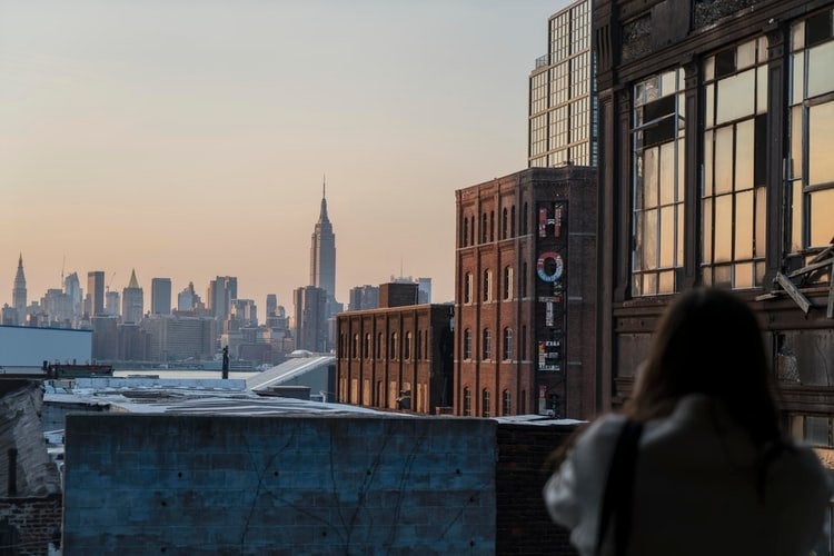 Woman standing on a balcony across from a \