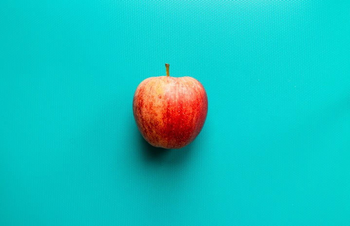 apple on blue surface