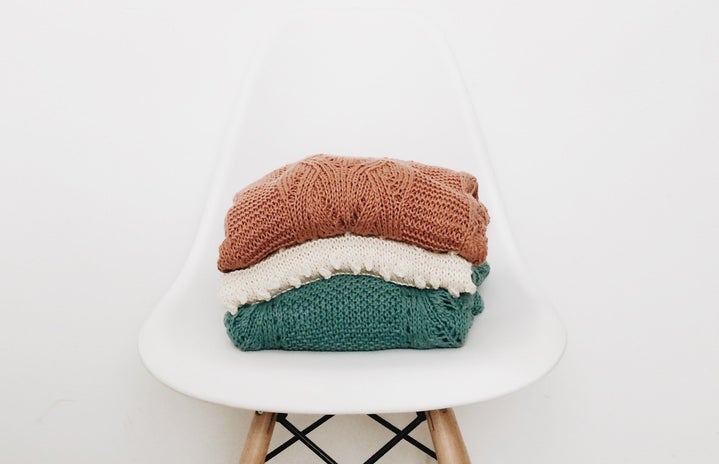 3 sweaters on white chair