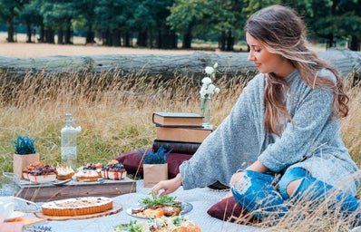 woman sitting on blanket having a picnic