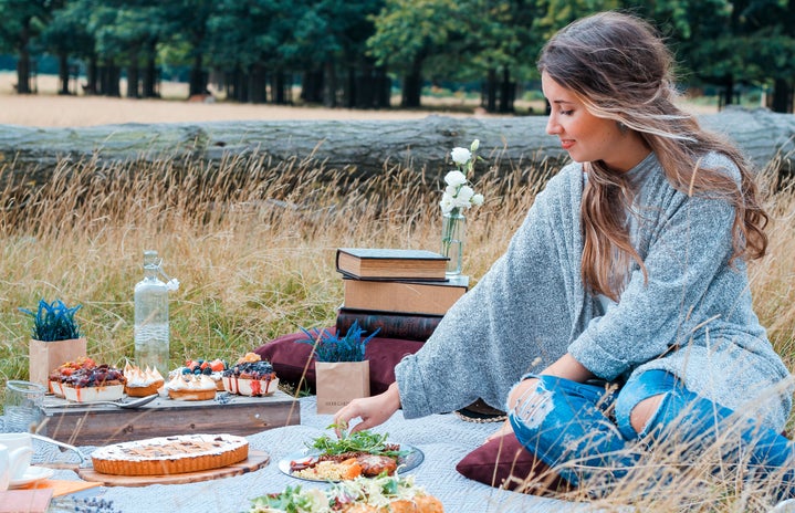 woman sitting on blanket having a picnic